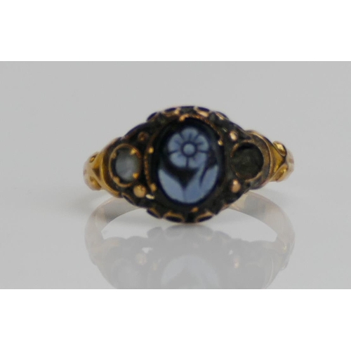 58 - A Victorian Mourning Ring set with a hardstone forget-me-not cameo and in a high carat precious yell... 