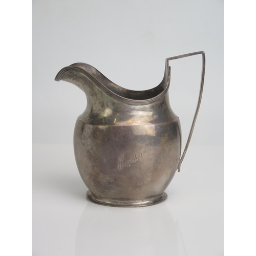 584 - A George V silver cream jug, maker George Nathan & Ridley Hayes, Chester, 1913, of plain barge-shape... 