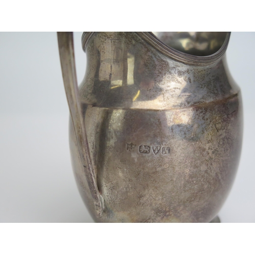 584 - A George V silver cream jug, maker George Nathan & Ridley Hayes, Chester, 1913, of plain barge-shape... 