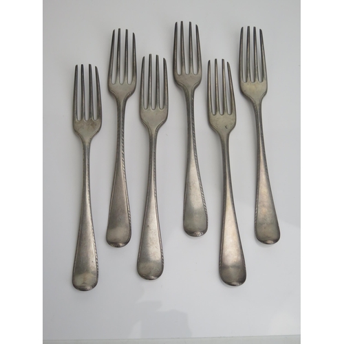 586 - A set of six Georgian silver Hanoverian and Feather pattern 
 table forks, all marks worn and rubbed... 