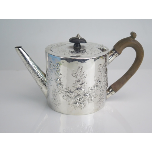 602 - A George III silver teapot, maker's mark worn, London, 1787,  crested, of cylindrical form, with flo... 