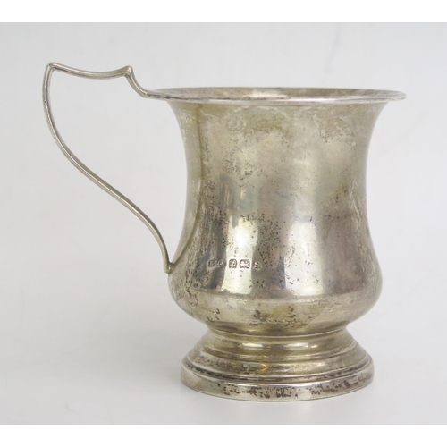 692 - A George V silver christening mug, of baluster form with swept handle on a circular foot, 8.5cm high... 