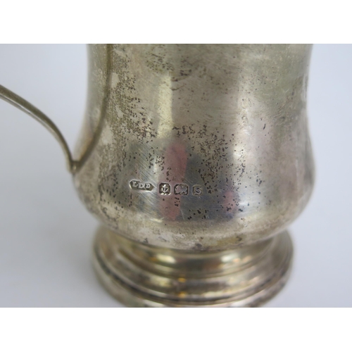 692 - A George V silver christening mug, of baluster form with swept handle on a circular foot, 8.5cm high... 