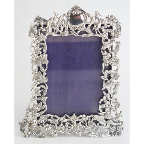 707 - A Victorian silver easel photograph frame, maker William Comyns & Sons, London, 1892, of arched outl... 