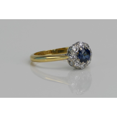 73 - An 18ct Gold, Blue Stone and Diamond Cluster Ring in a platinum setting, c. 14.6mm head, stamped 18C... 