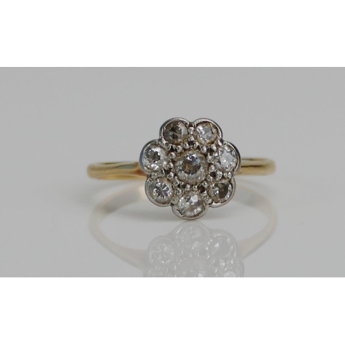 75 - An Old Cut Diamond Flower Head Cluster Ring in a high carat precious white and yellow metal setting,... 