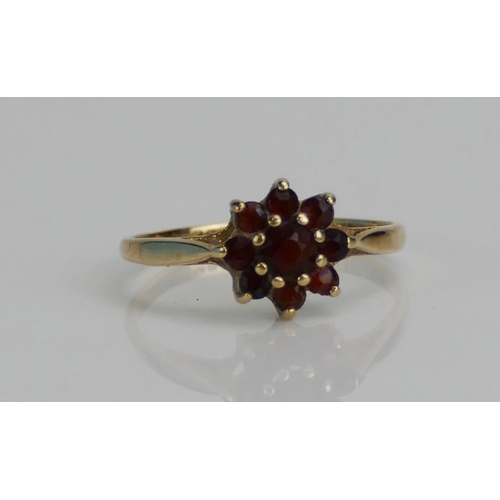 79 - A 9ct Gold and Garnet Cluster Ring, size J, hallmarked, 1.18g together with a filigree necklace and ... 