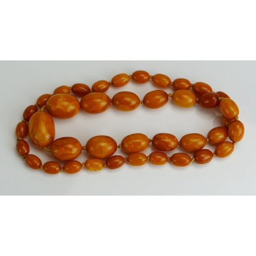 85 - A Baltic Amber Graduated Bead Necklace, 
largest bead c. 32.7x24mm, c. 73cm, 63.14g