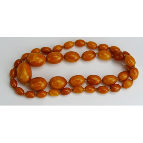 85 - A Baltic Amber Graduated Bead Necklace, 
largest bead c. 32.7x24mm, c. 73cm, 63.14g