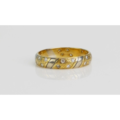 97 - An 18ct Yellow and White Gold and Diamond Band, 4mm wide, size N.75, hallmarked, 3.43g