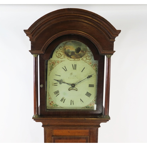 1253 - A 19th century oak longcase clock, the arched hood with turned columns, the trunk with cross banded ... 