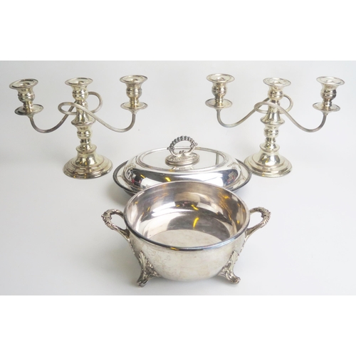 666 - A pair of plated twin branch candelabra, a plated entree dish and cover, serving dish.