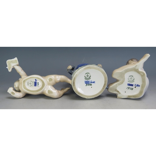 1183 - Three Royal Copenhagen porcelain figures, No 3556 Boy with Umbrella, No 1739 Crawling Child, and No ... 