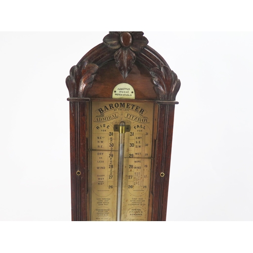 1255A - An oak cased Admiral Fitzroy barometer by J.J.Bettle Petersfield, with printed paper scale, thermome... 