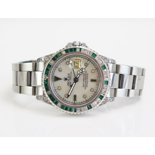 291 - A ROLEX Oyster GMT-MASTER Steel Cased Wristwatch with aftermarket emerald and diamond bezel and to t... 