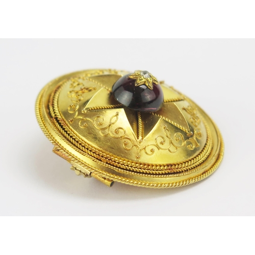 1 - A Victorian High Carat Precious Yellow Metal Shield Brooch with central polished garnet cabochon and... 