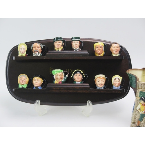 1010 - A set of twelve Royal Doulton miniature Dickens character jugs, with polished wood shelf and The whi... 