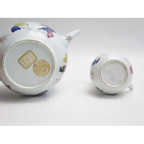 1038 - A Liverpool porcelain teapot and cream jug decorated in the Chinoiserie taste. A/F.