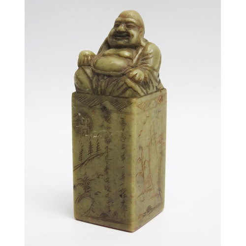 1047 - A Chinese carved hardstone seal, of rectangular outline surmounted by a seated Budai, 11.5cm high, b... 