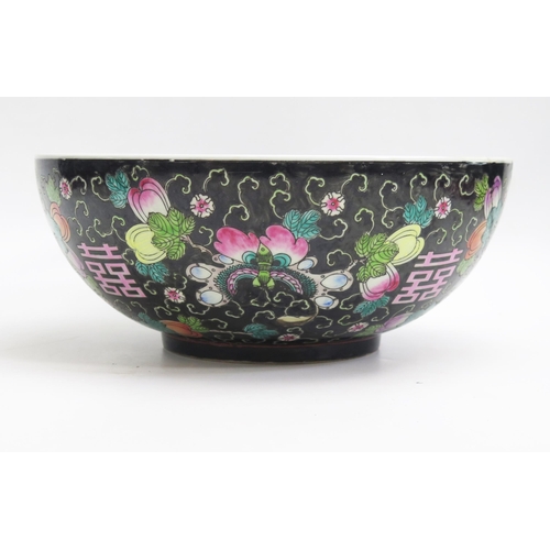 1054 - A Chinese bowl, with painted floral decoration to a black ground, 33cm diameter