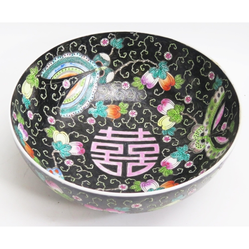 1054 - A Chinese bowl, with painted floral decoration to a black ground, 33cm diameter