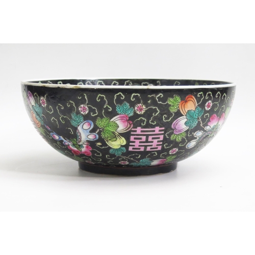 1054 - A Chinese bowl, with painted floral decoration to a black ground, 33cm diameter