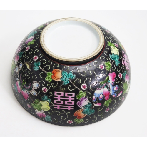 1054 - A Chinese bowl, with painted floral decoration to a black ground, 33cm diameter