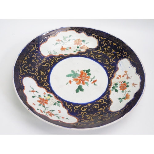 1057 - A Chinese charger, decorated in the Imari palette with birds and flowering shrubs, 41cm diameter.