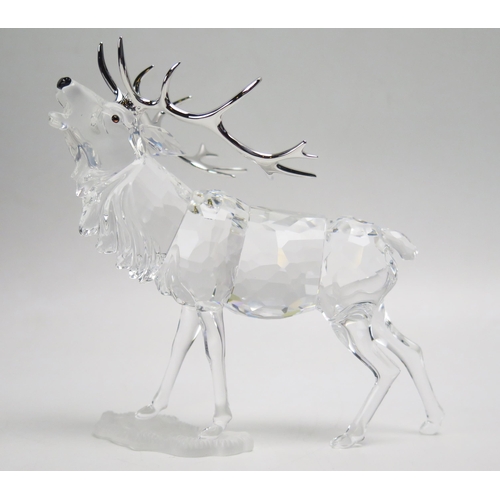 1096 - A Swarovski crystal model of a caribou with silvered antlers, 14cm high, boxed.