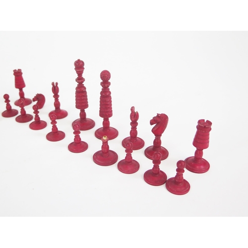 1225 - A 19th century bone chess set, one side stained red the other left natural, the king 7.5cm, the pawn... 