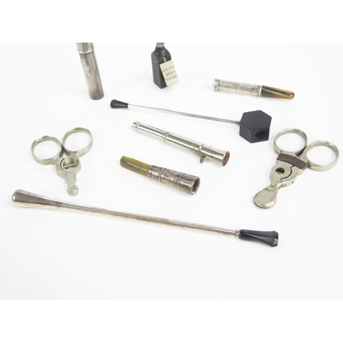 1226 - An Art Deco period chrome and Bakelite cigarette holder, three cigar cutters, cheroot holders etc.