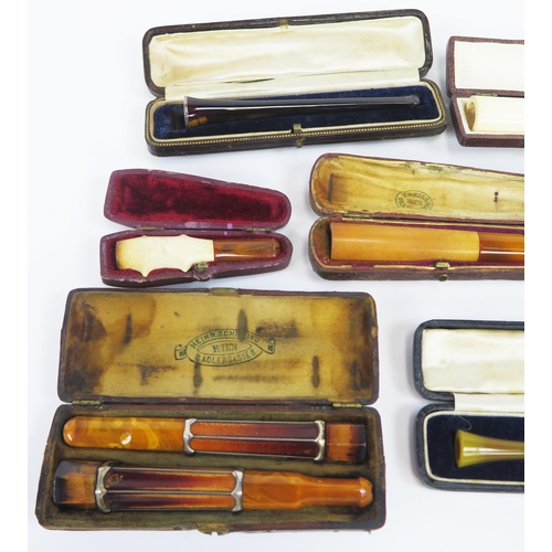 1227 - A collection of amber and other cheroot and cigarette holders, all cased.