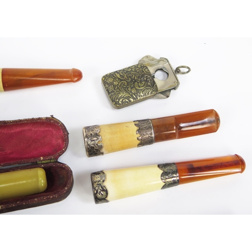 1229 - A collection of assorted amber and other cheroot and cigarette holders.