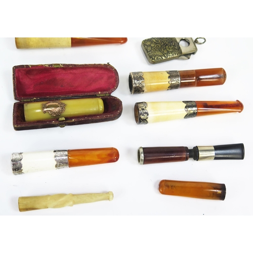 1229 - A collection of assorted amber and other cheroot and cigarette holders.