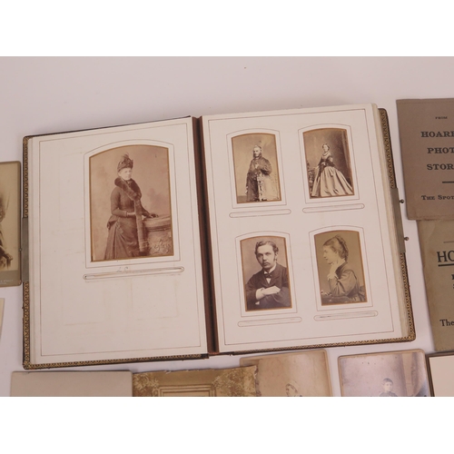 1237 - A Victorian photograph album containing various photographs and carte-de-visites, together with loos... 