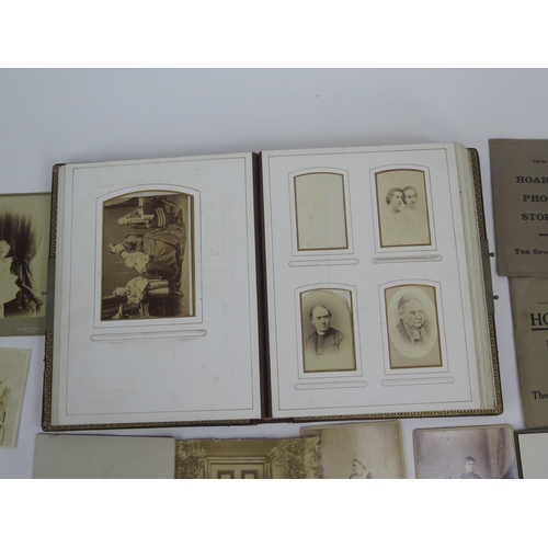 1237 - A Victorian photograph album containing various photographs and carte-de-visites, together with loos... 