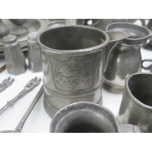 1245 - A large collection of assorted pewter wares, includes plates mugs condiments, spoons, candlestick, r... 