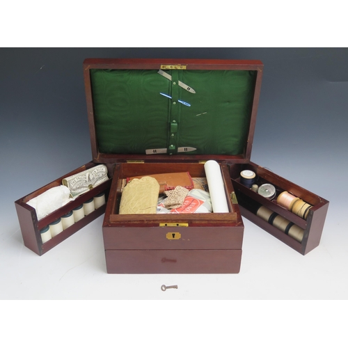 1311 - A mahogany and boxwood inlaid sewing box, the hinged lid enclosing a fitted interior of hinged compa... 