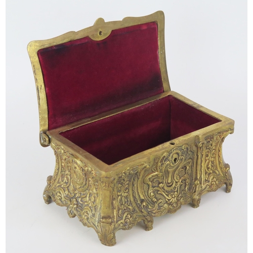 1361 - A cast brass rectangular jewellery casket, in the Italianate style, the hinged lid enclosing a velve... 