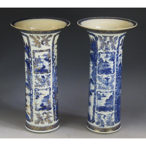 1382 - A pair of Chinese blue and white sleeve vases, with pagoda landscape decoration, heightened in gilt,... 