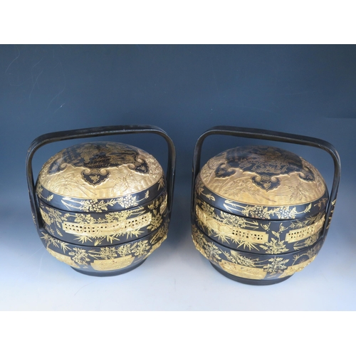 1391 - Two 19th century style Chinese black lacquered food baskets and cover, with gilt decoration and loop... 