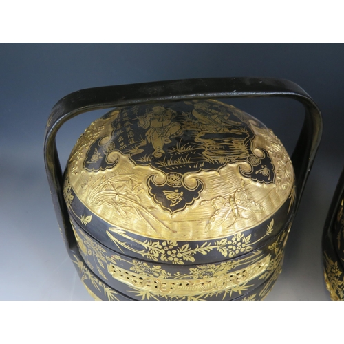 1391 - Two 19th century style Chinese black lacquered food baskets and cover, with gilt decoration and loop... 