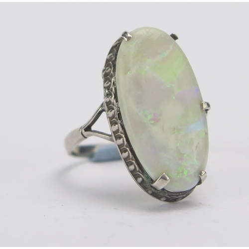 141 - A Singlet Opal and Silver Ring, 21.6x11.3mm stone. Claws damaged