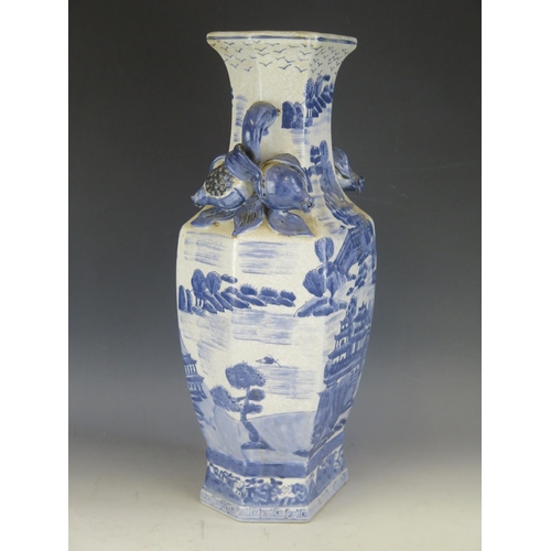 1410 - A large 20th Century Chinese blue and white vase, of polygonal outline with all over landscape decor... 