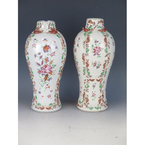 1415 - A pair of 19th century Chinese famille rose vases with raised floral decoration, a/f, 26cm high.