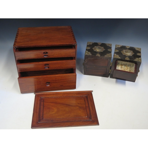 1430 - A modern Chinese hardwood box, th26cm wide. e sliding front enclosing three drawers, with loop handl... 