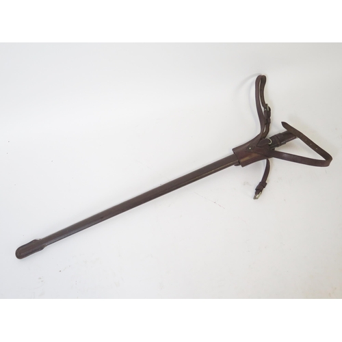 1534 - A late Victorian British socket bayonet with 54cm triangular blade, contained in a leather sheath. W... 