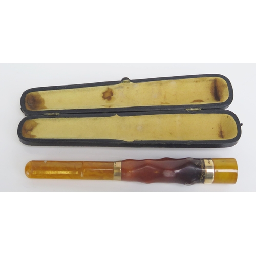 1540 - An amber cheroot holder, contained in a Morocco leather case.