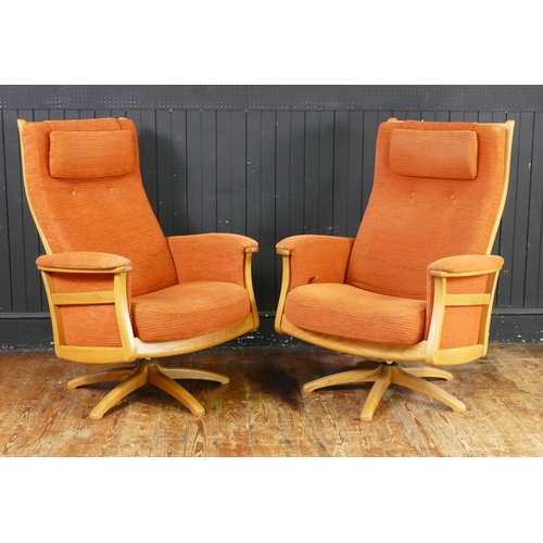 1647 - An Ercol Three Piece Suite in salmon pink with twin swivel armchairs