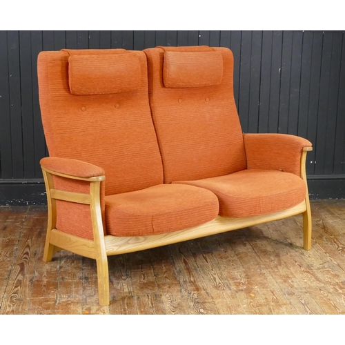 1647 - An Ercol Three Piece Suite in salmon pink with twin swivel armchairs